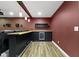 Finished basement bar area features a beverage cooler, modern lighting, and wood look flooring at 543 Amersham Ct, Avon, IN 46123