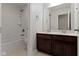 Well-lit bathroom features a double sink vanity, tub and shower combination, and tile flooring at 543 Amersham Ct, Avon, IN 46123