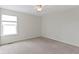 Bright bedroom features neutral walls, carpet, ceiling fan, and large window with bright light at 543 Amersham Ct, Avon, IN 46123
