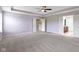Large primary bedroom features a ceiling fan, plush carpet, and ensuite bathroom at 543 Amersham Ct, Avon, IN 46123
