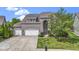 Inviting brick home with a three-car garage, beautiful lawn, and mature trees at 543 Amersham Ct, Avon, IN 46123
