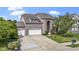 Charming brick home featuring a three-car garage and manicured front lawn at 543 Amersham Ct, Avon, IN 46123