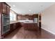 Spacious kitchen with stainless appliances, hardwood floors, granite counters, and abundant stained wood cabinetry at 543 Amersham Ct, Avon, IN 46123