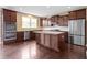 Gourmet kitchen featuring stainless appliances, granite counters, and dark stained wood cabinetry at 543 Amersham Ct, Avon, IN 46123