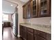 This kitchen features granite countertops and dark wood cabinetry with glass doors at 543 Amersham Ct, Avon, IN 46123