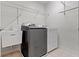 Bright laundry room with washer, dryer, sink, wire shelving, and tile flooring at 543 Amersham Ct, Avon, IN 46123