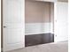 The bright living room has dark hardwood floors visible behind the open, white doors at 543 Amersham Ct, Avon, IN 46123