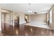 A large living room featuring hardwood floors, neutral paint, and an open staircase at 543 Amersham Ct, Avon, IN 46123