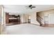 Bright, open-concept living room with hardwood floors, ceiling fan, and kitchen access at 543 Amersham Ct, Avon, IN 46123