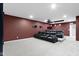 Home theater room features carpet, projector, bar lights, leather seats, and burgundy walls at 543 Amersham Ct, Avon, IN 46123