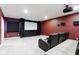 Home theater room features carpet, projector, black screen, leather seats, and burgundy walls at 543 Amersham Ct, Avon, IN 46123