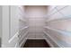 A walk-in closet with wrap around wire shelving and dark hardwood floors provides ample storage at 543 Amersham Ct, Avon, IN 46123