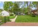 A spacious backyard with lush greenery, a detached garage, and a well-maintained lawn, perfect for outdoor activities at 5616 Winthrop Ave, Indianapolis, IN 46220