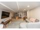 Finished basement featuring a large tv, seating area, hardwood floors, and a musical instrument set at 5616 Winthrop Ave, Indianapolis, IN 46220