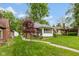 Inviting brick home with beautiful landscaping and mature trees at 5616 Winthrop Ave, Indianapolis, IN 46220