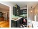 Charming kitchen featuring dark green cabinetry, stainless steel appliances, and a black and white checkered floor at 5616 Winthrop Ave, Indianapolis, IN 46220