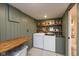 Efficient laundry room with washer, dryer, folding table, and storage shelves, offering functionality and organization at 5616 Winthrop Ave, Indianapolis, IN 46220
