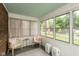 Bright sunroom with large windows offering pleasant outdoor views at 5616 Winthrop Ave, Indianapolis, IN 46220