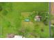 Top-down aerial view of a property featuring a pool, a large yard, and lush greenery at 6012 S 625 W, Pendleton, IN 46064