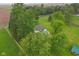 Aerial view of home, a small body of water, and surrounding greenery at 6012 S 625 W, Pendleton, IN 46064