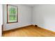 Bedroom featuring hardwood floors, baseboard trim, and a large window at 6012 S 625 W, Pendleton, IN 46064