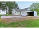 Home featuring a driveway, garage, and carport, complemented by lush greenery and well-maintained landscaping at 6012 S 625 W, Pendleton, IN 46064
