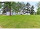 Green grass leads to a home with an attached garage under a cloudy sky at 6012 S 625 W, Pendleton, IN 46064