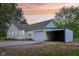 Charming home featuring a garage and large carport, all set against a backdrop of a colorful sunset at 6012 S 625 W, Pendleton, IN 46064