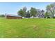 Farm property with a brick outbuilding and house in the distance at 6012 S 625 W, Pendleton, IN 46064