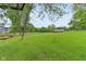 Large green yard with a small barn and outbuilding in the distance at 6012 S 625 W, Pendleton, IN 46064