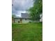 Backyard view of home exterior and green lawn at 6117 Marilyn Rd, Indianapolis, IN 46226