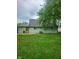 Backyard view of home exterior and green lawn at 6117 Marilyn Rd, Indianapolis, IN 46226