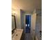 Bathroom with tiled shower/tub, vanity with sink, and an adjacent room visible at 6117 Marilyn Rd, Indianapolis, IN 46226