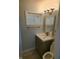Bathroom with a vanity sink, modern faucet, and updated light fixture at 6117 Marilyn Rd, Indianapolis, IN 46226
