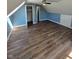 Bedroom with updated flooring, large closet, and ceiling fan at 6117 Marilyn Rd, Indianapolis, IN 46226