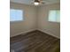 Bedroom with updated flooring and two windows, with a ceiling fan at 6117 Marilyn Rd, Indianapolis, IN 46226