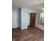 Bedroom featuring wood floors, closet, and blue accent wall at 6117 Marilyn Rd, Indianapolis, IN 46226