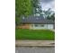 Charming single-story home with a well-manicured lawn and a bright yellow front door at 6117 Marilyn Rd, Indianapolis, IN 46226