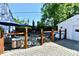 Backyard featuring a wooden fence, patio, a hot tub, and lush greenery providing a private outdoor space at 6187 Crittenden Ave, Indianapolis, IN 46220