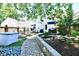 Spacious backyard features a patio, hot tub, and a rock-lined koi pond, all connected by a paved walkway at 6187 Crittenden Ave, Indianapolis, IN 46220