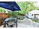 Inviting backyard with an outdoor dining area, koi pond, hot tub, and beautifully landscaped gardens at 6187 Crittenden Ave, Indianapolis, IN 46220
