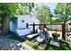 Backyard featuring a hot tub, lounge chairs on artificial turf, and brick pavers for a stylish outdoor space at 6187 Crittenden Ave, Indianapolis, IN 46220