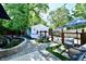 Private backyard with a patio, lush landscaping, a hot tub, and a detached garage at 6187 Crittenden Ave, Indianapolis, IN 46220