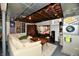 Comfortable basement featuring a cozy seating area, exposed ceiling, and stylish decor at 6187 Crittenden Ave, Indianapolis, IN 46220