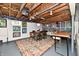 Basement featuring exposed wood ceiling, bar seating, dining area, and stylish decor at 6187 Crittenden Ave, Indianapolis, IN 46220