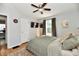 Comfortable bedroom with ceiling fan, neutral colors, natural light, and easy access to an office space at 6187 Crittenden Ave, Indianapolis, IN 46220