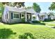 Attractive home with stone accents, a covered porch, and a well-maintained lawn at 6187 Crittenden Ave, Indianapolis, IN 46220