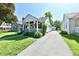 Charming home with a front porch, well-manicured lawn, and a long driveway leading to a detached garage at 6187 Crittenden Ave, Indianapolis, IN 46220