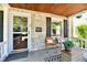 Inviting front porch with stone wall, chairs, and decor, perfect for relaxing outdoors at 6187 Crittenden Ave, Indianapolis, IN 46220