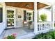 Inviting front porch with stone wall, chairs, and decor, perfect for relaxing outdoors at 6187 Crittenden Ave, Indianapolis, IN 46220